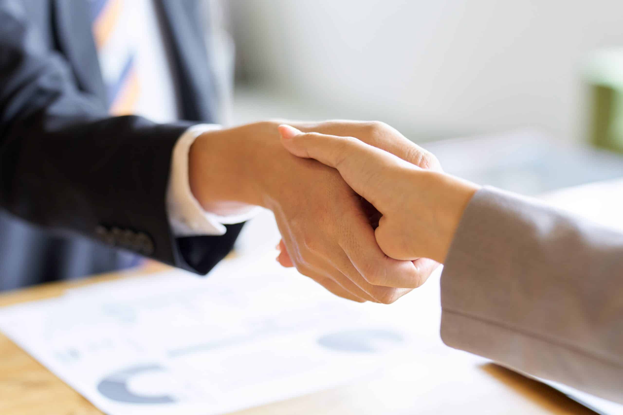 Handshake agreement between two professionals at F3 Private Investigations, a trusted private investigation company.