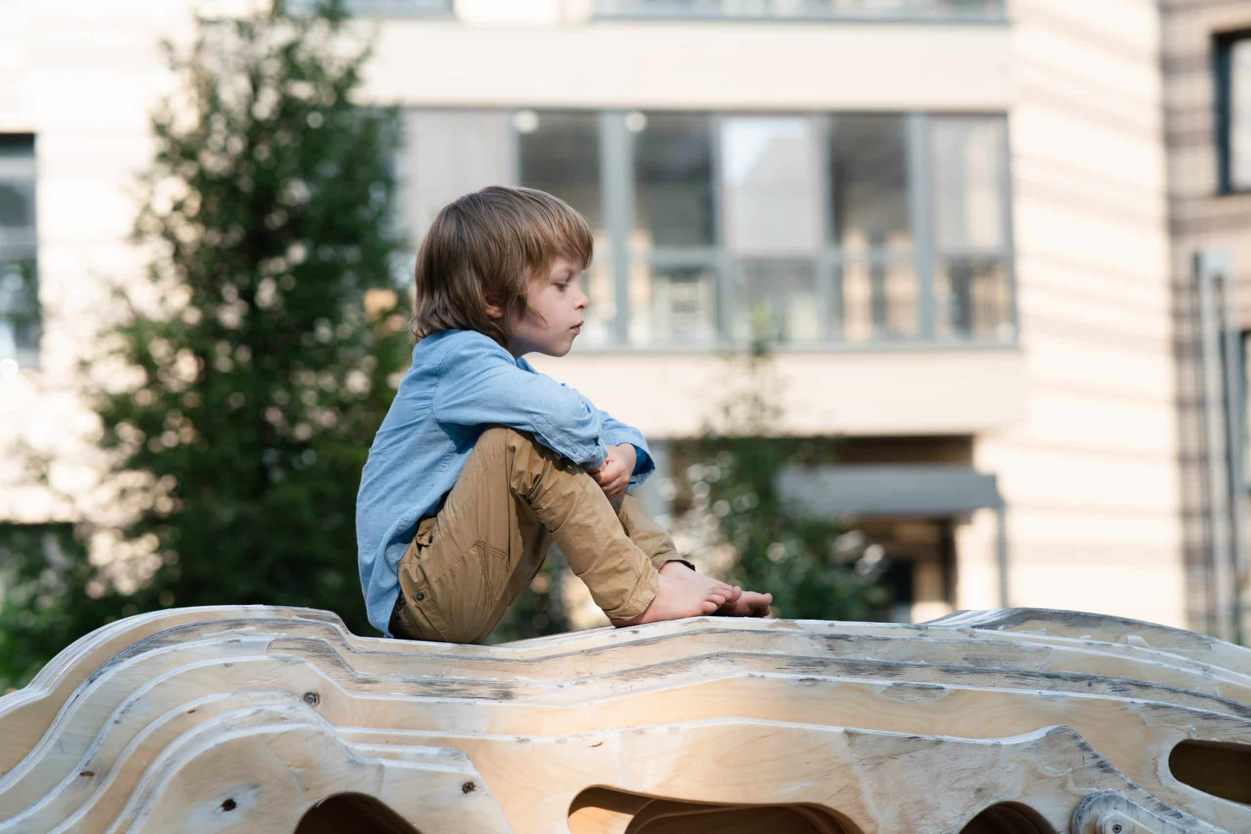 Young child sitting quietly outdoors. F3 Private Investigations ensures safety and care in locating missing persons.