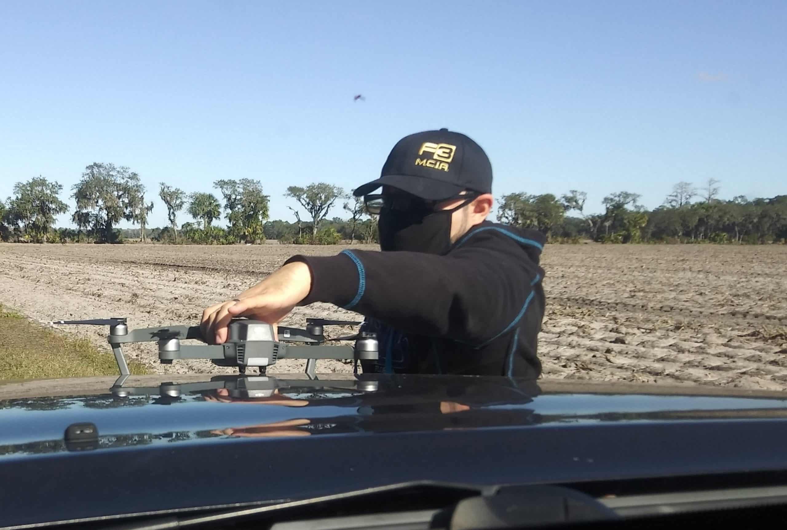 Investigator from F3 Private Investigations using a drone for surveillance in a rural area.