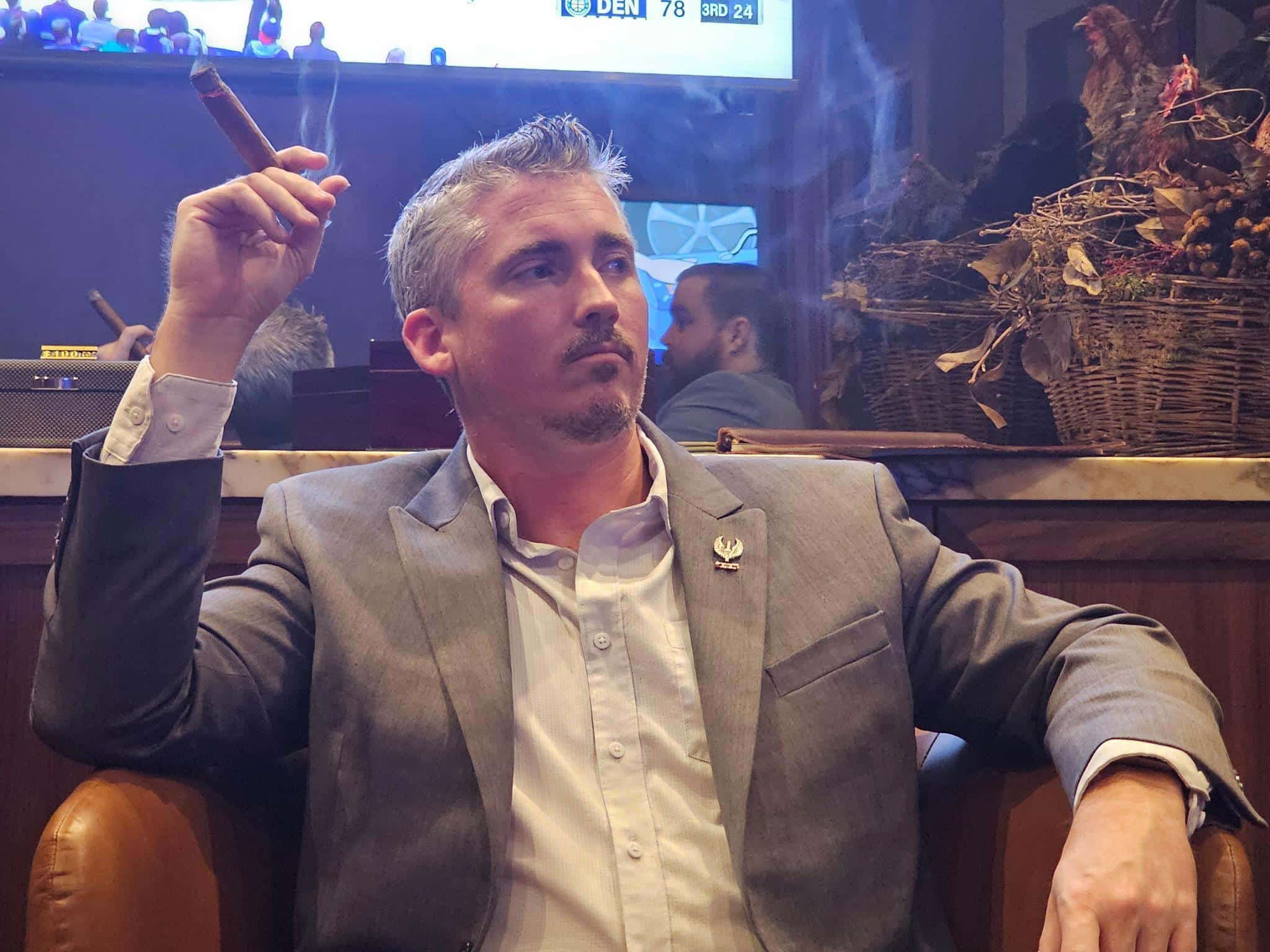 Man in a suit smoking a cigar