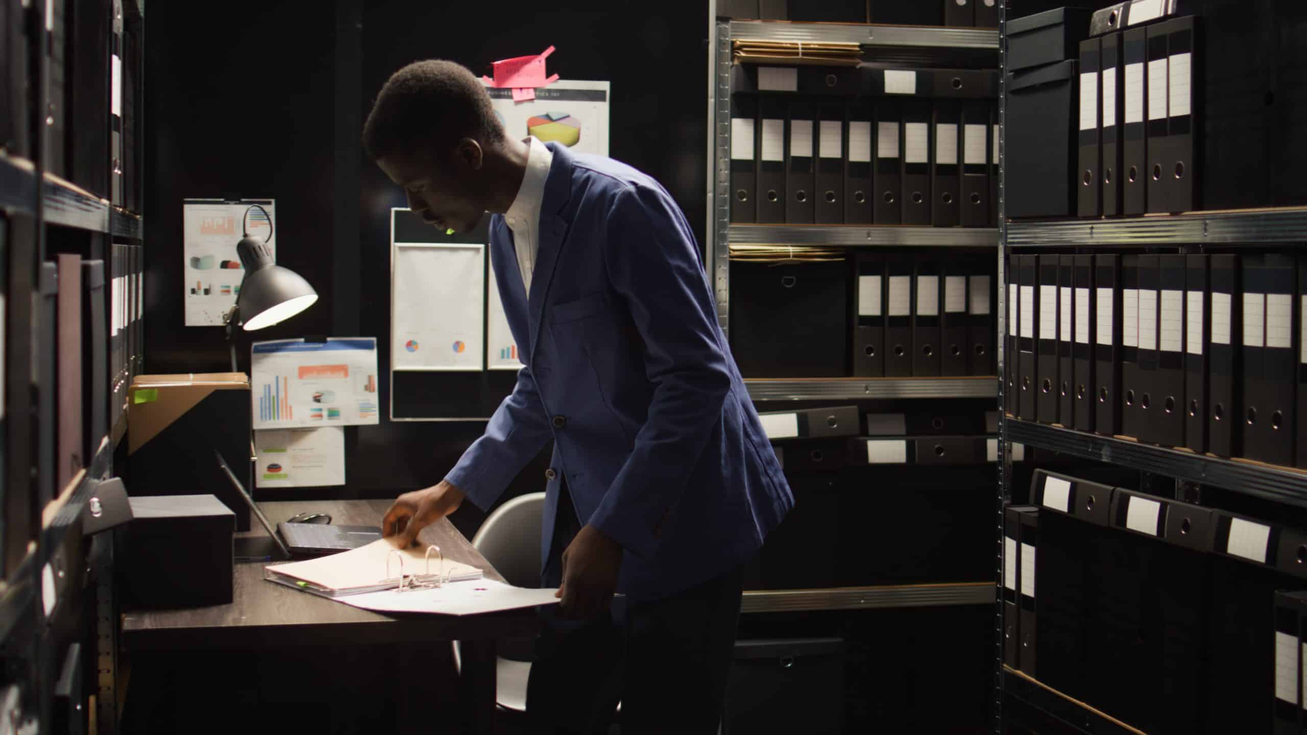 Man organizing documents in office