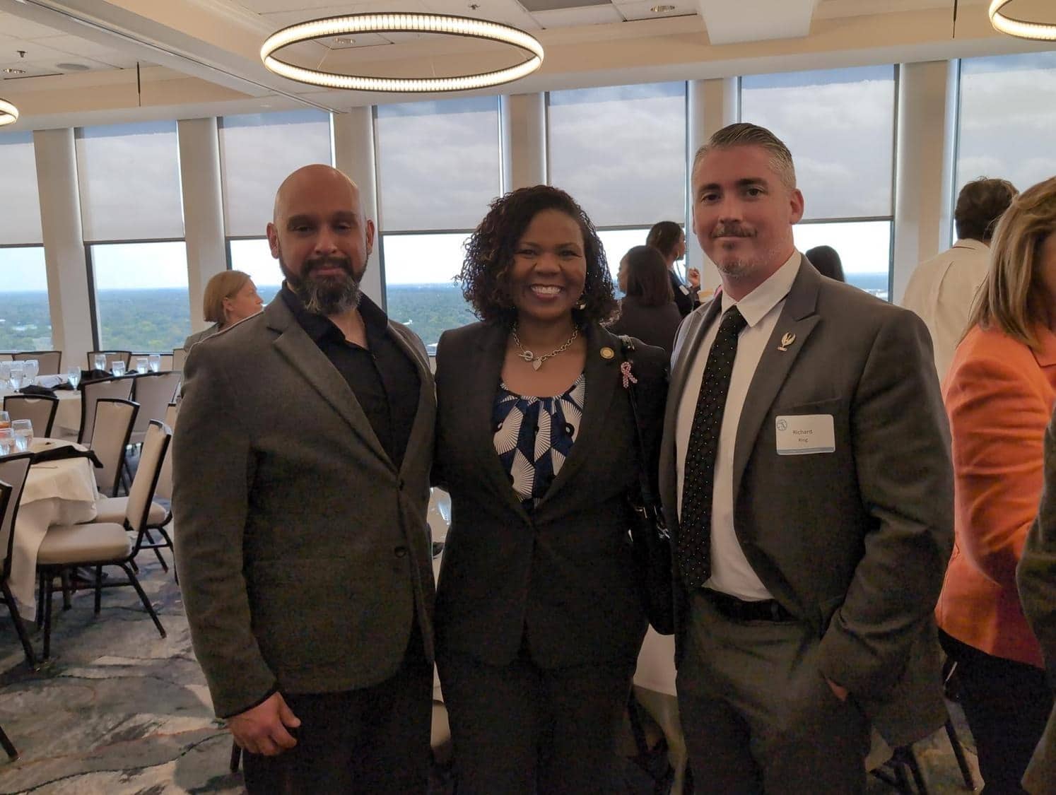 Three people attending a formal event together.