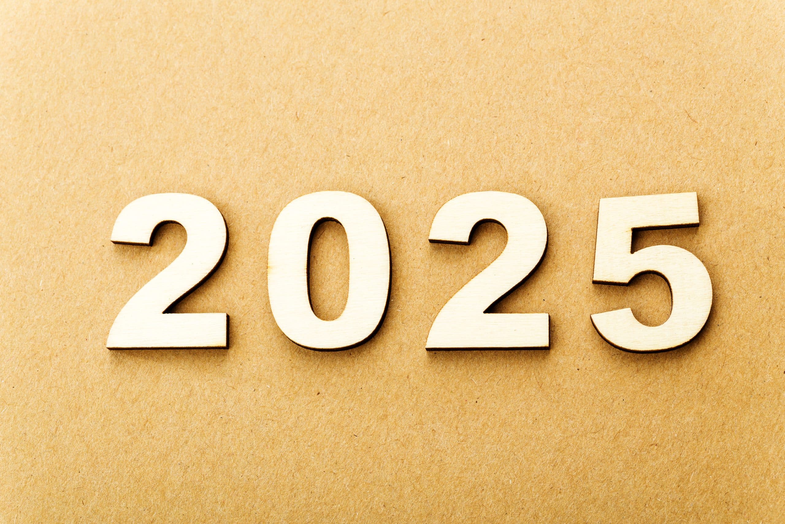 Wooden 2025 numbers on brown paper background